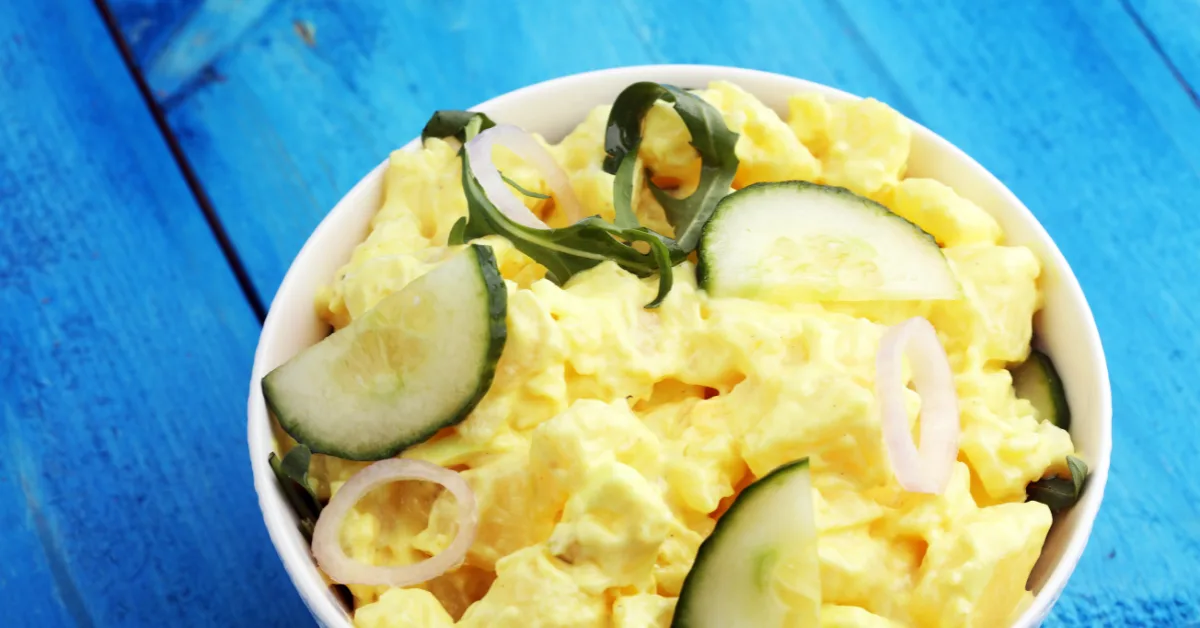 A delicious homemade creamy egg salad on a picnic table.